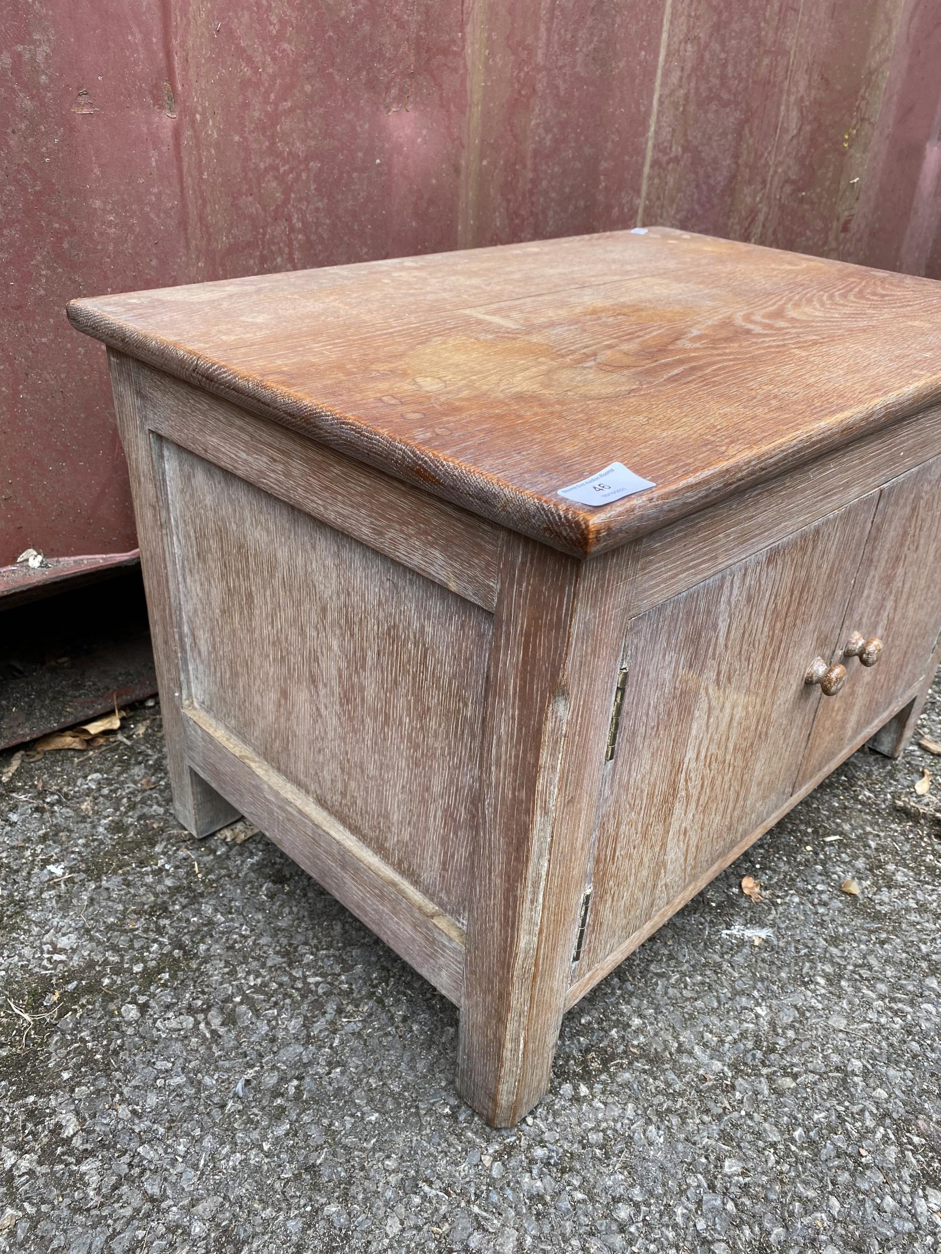 Attributed to Heals a 1950s limed oak small cupboard having two cupboard doors and standing on block - Image 2 of 4