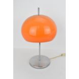 A 1970s mushroom table lamp in the style of Harvey Guzzini having an orange shade and on a chrome