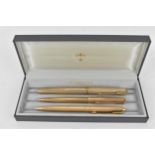 A Parker pen set to include a 9ct gold fountain pen, a 9ct gold ball point and a gold coloured