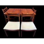 A mid 20th century Alexander Henry Mcintosh extending rosewood dining table and a set of four dining