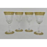 A set of four Saint Louis crystal glasses with thistle shaped bowls with an etched and gilt vine