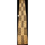 A Kuba long cloth with repeating stylized pattern, 350cm x 51cm