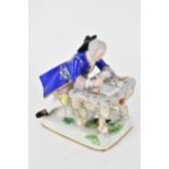 A 19th century Meissen figure of a gentleman seated at a writing table comprising a love letter,