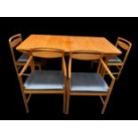 A mid 20th century Alexander Henry McIntosh teak extending dining table and four chairs, two being
