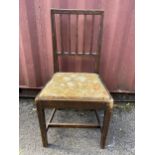 A 1920s Gordon Russell oak single dining chair, model no 296, having drop in seat and squared legs