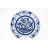 An 18th century Delft blue and white bleeding shaving bowl, with floral decoration, 22cm d