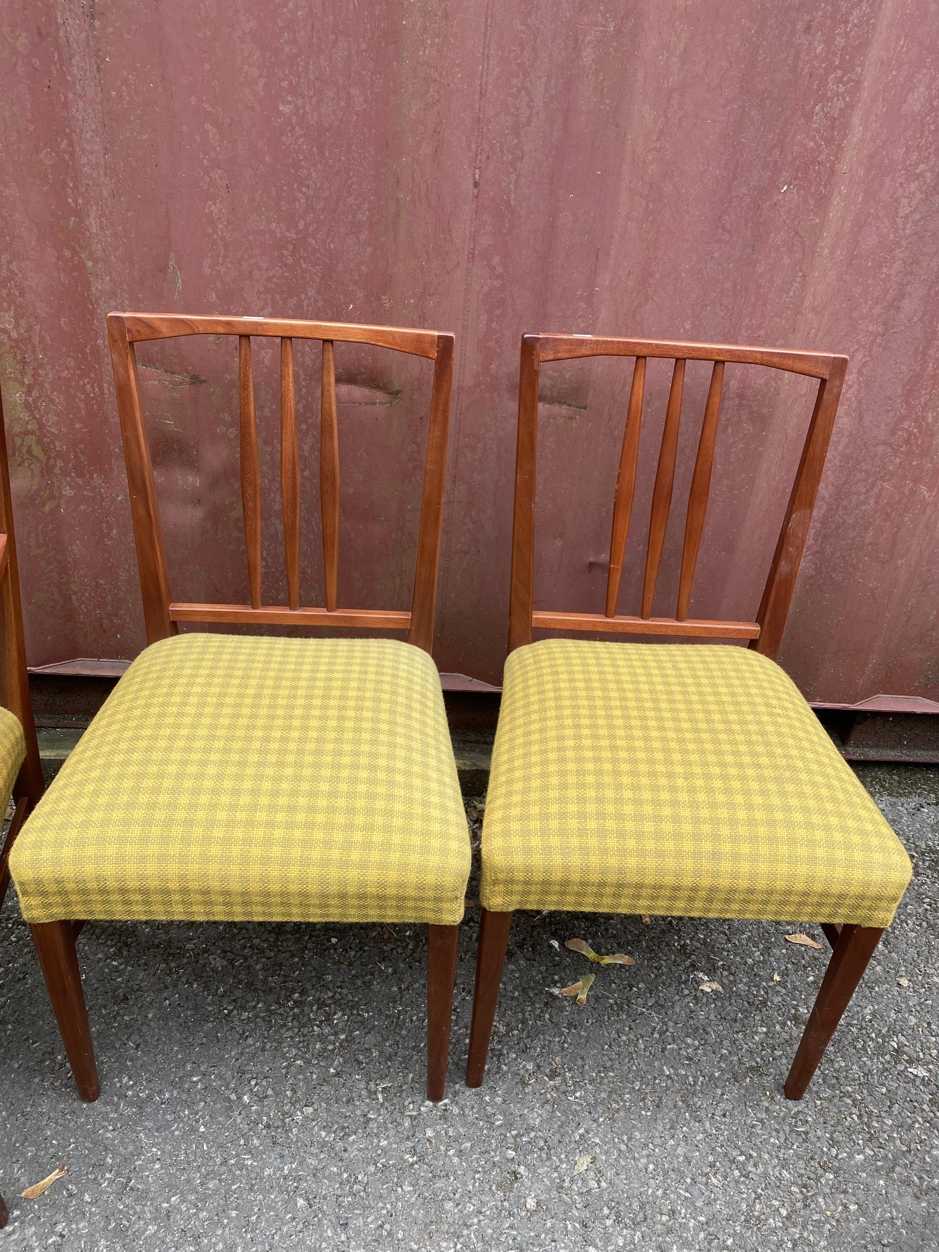 A set of four Gordon Russell 1950s teak dining chairs, model 6409 and 6408, designed by W.H Curly, - Image 2 of 3