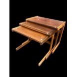 A nest of three mid 20th century rosewood tables, possibly by Salin Nyborg, having C shaped ends and