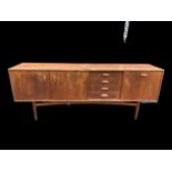 A 1960's Victor Wilkins for G-Plan 'Brasilia' teak sideboard, the four drawers flanked by a pair and