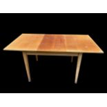 Attributed to Gordon Russell a 1950s teak extending dining room table on square tapering legs, 75.5h