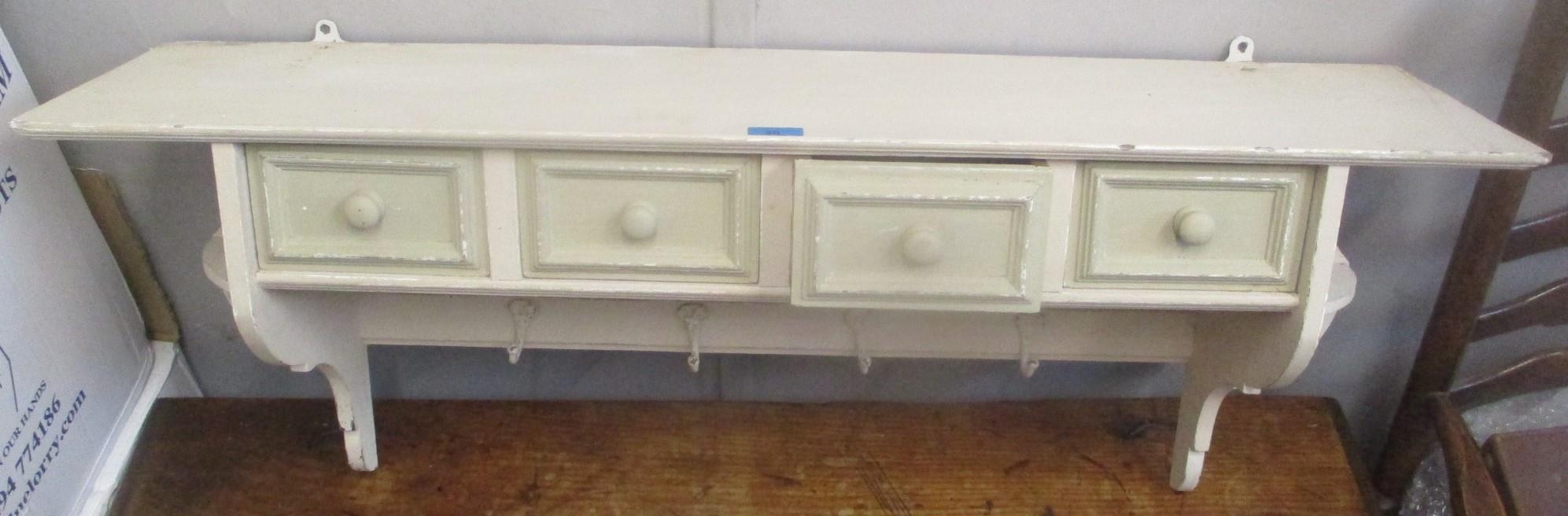 A painted pine shelf with four drawers and hooks, 42cm h x 104.5cm w