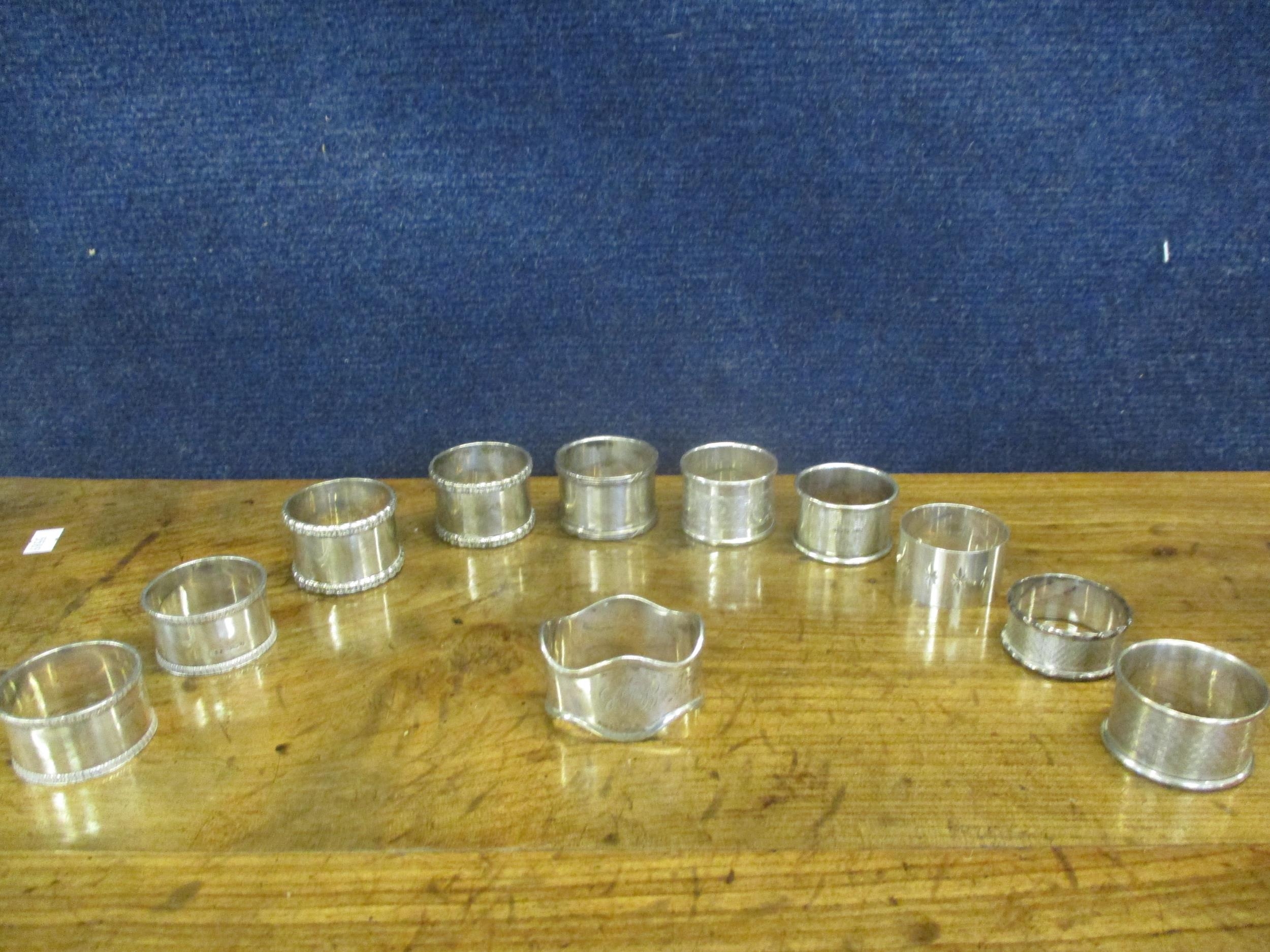 A collection of silver napkin rings, 325g (11 in total) Location: Cab