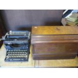 A vintage Underwood typewriter made in India, together with a vintage sewing machine in oak case