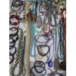 A quantity of costume jewellery to include mainly bracelets and necklaces, silver items, a dragonfly