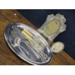 Silver and silver plated items to include two muffin forks, a silver plated oval tray, grape