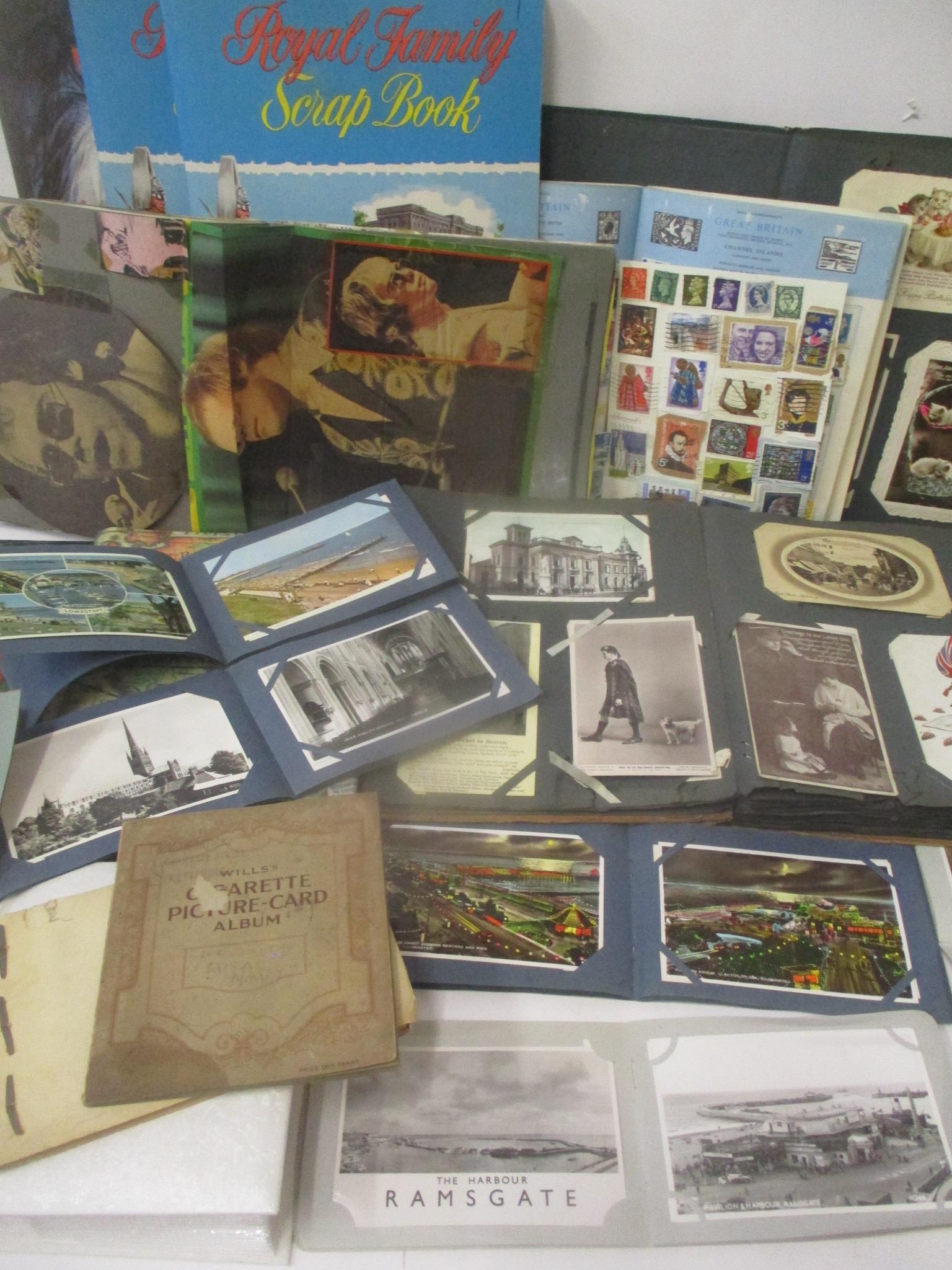 A mixed lot to include postcards, cigarette cards, stamps and scrap albums