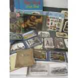 A mixed lot to include postcards, cigarette cards, stamps and scrap albums