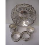 Four silver napkin rings and a silver dish with pierced decoration, 157g