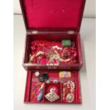 A collection of costume jewellery together with a red leather jewellery box Location: port