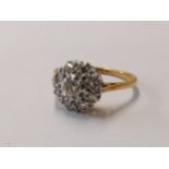 An 18ct gold and diamond cluster ring size M, total weight 3.3g, having a platinum setting Location: