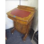 A Victorian burr walnut Davenport having a red leather topped scriber, marquetry inlaid and four