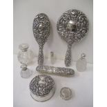 A Victorian silver backed three-piece dressing table set, and a similar later silver ring box, all