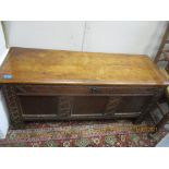 A 17th /18th century oak coffer with carved tri-panelled front, interior candle box, on stile