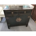 A 20th century Chinese black lacquered side cabinet, with two drawers over two cupboard doors, 85