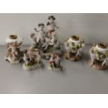 A Capodimonte porcelain group of five puttis, together with three German porcelain oil lamp bases