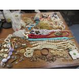 A mixed lot of costume jewellery to include beaded necklaces, a brass cased Elbon ladies wristwatch,