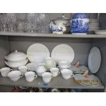 A Wedgwood Candlelight pattern white glazed part dinner service with moulded wrythen decoration, and