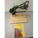 A shoe mending machine with instructions Location: RWM