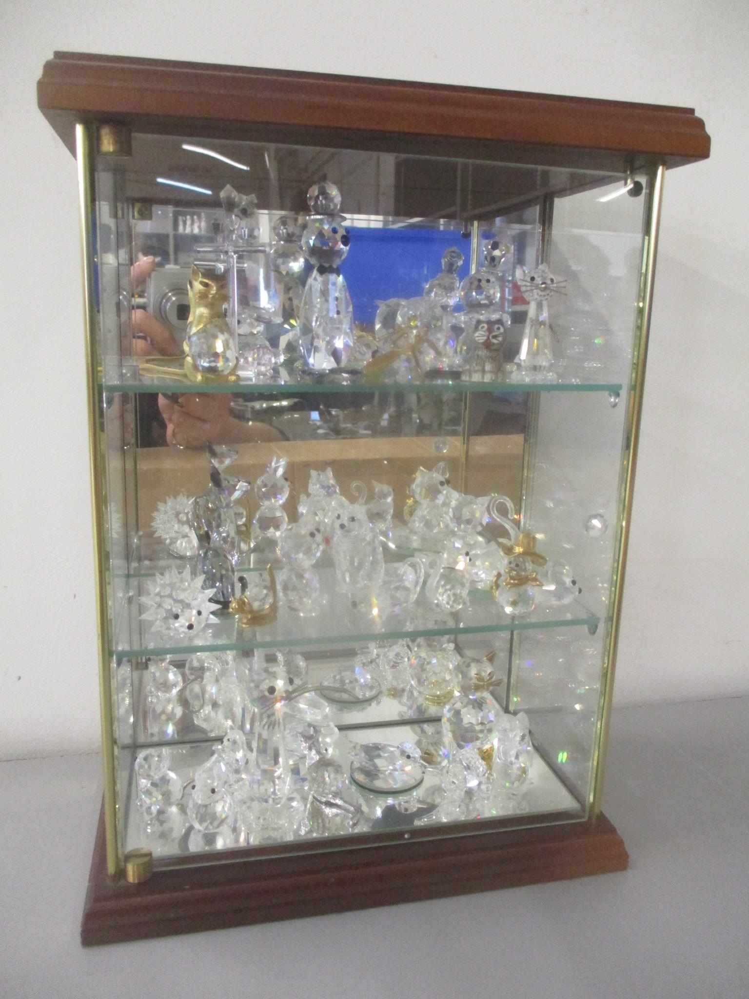 A selection of mainly Swarovski crystal animal ornaments (approx 28) contained in a glazed display