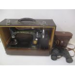 A Singer sewing machine serial no EG854033 and a pair of Swift binoculars