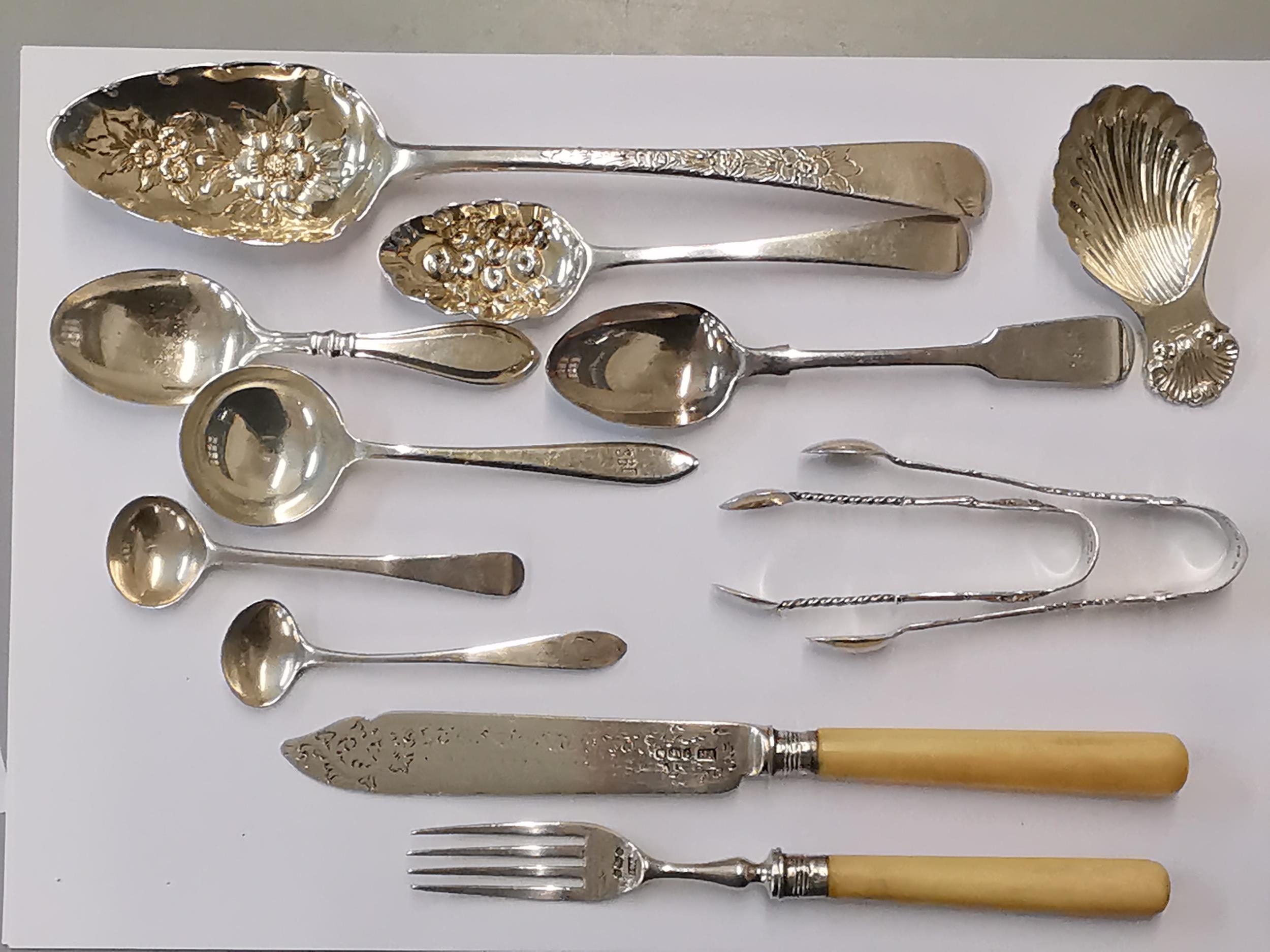 Silver to include two Georgian berry spoons, two Georgian teaspoons, a Victorian teaspoon, a caddy