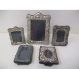 Five late 20th century silver fronted photograph frames with embossed decoration