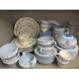 Wedgwood Esturia blue ground tableware with raised frieze of foliage in white, together with a