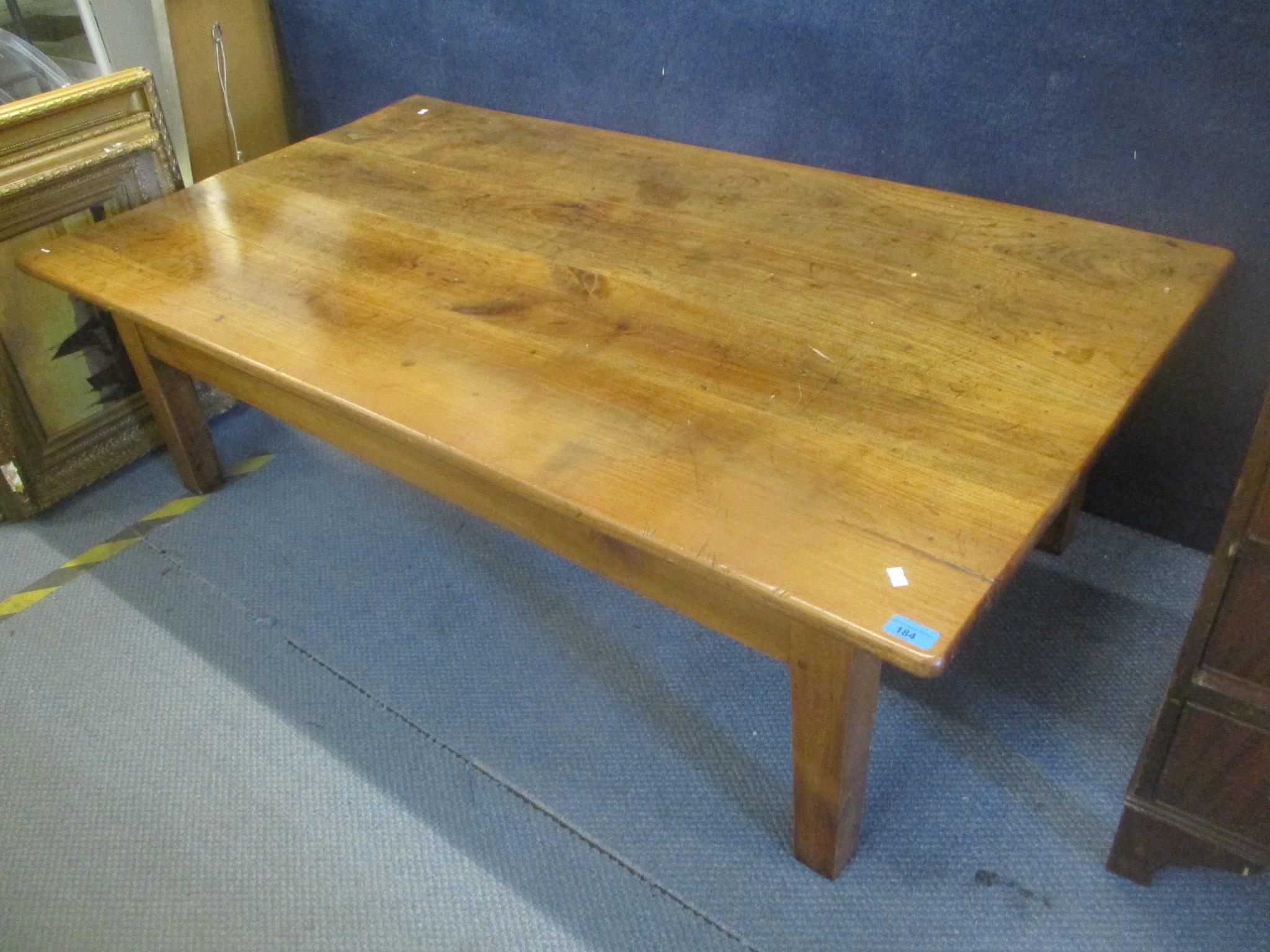 A French elm coffee table having a single inset drawer and standing on block shaped legs, 46cm h x