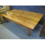 A French elm coffee table having a single inset drawer and standing on block shaped legs, 46cm h x