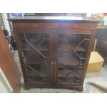 An early 20th century mahogany display cabinet, twin astragal glazed doors, three internal