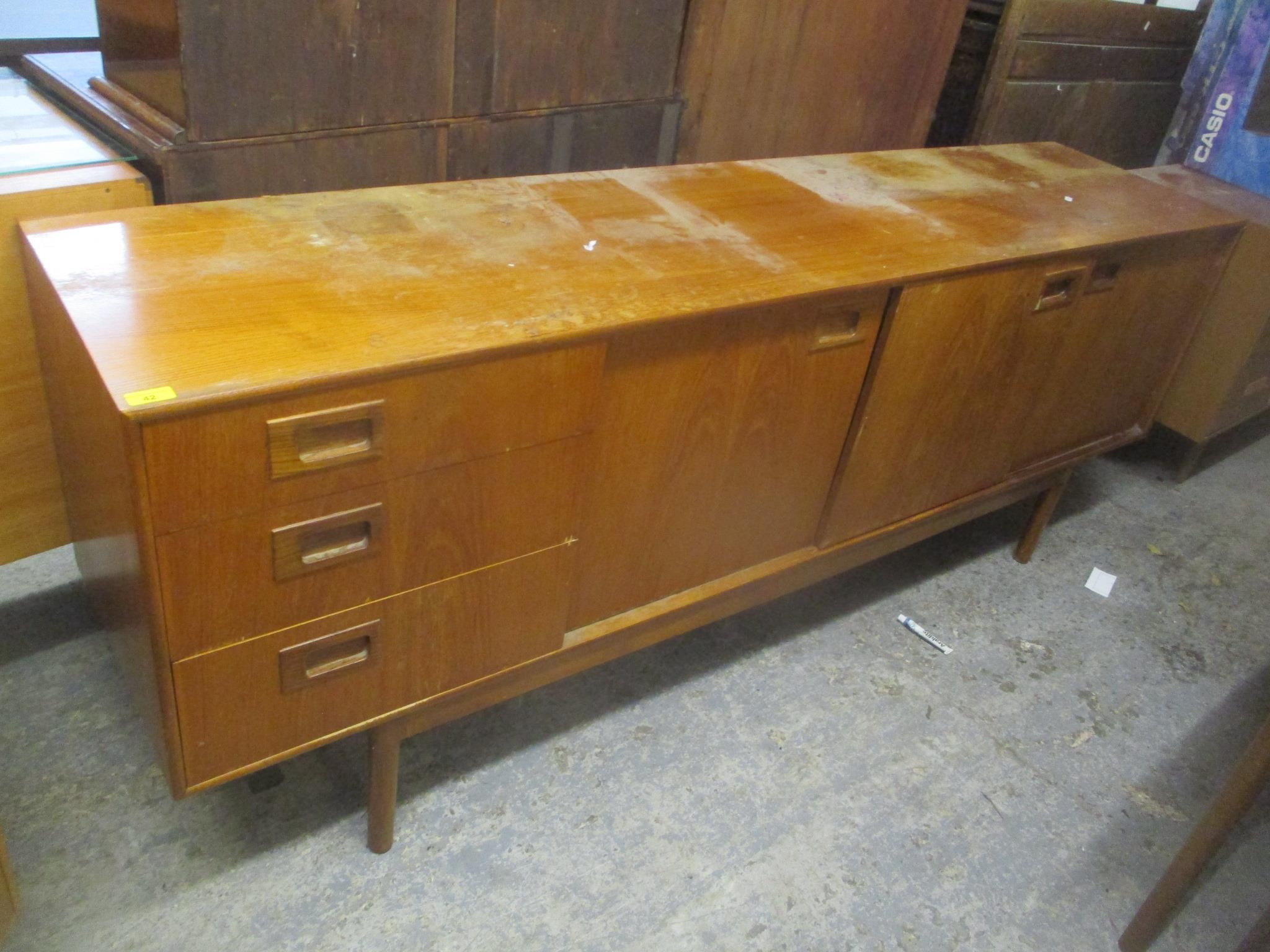 A mid 20th century retro teak sideboard having three drawers, one pull-down door and two sliding