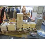 A large selection of collectors plates, plate hangers, and a plate wall hanging shelf unit to