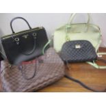 Four modern ladies handbags in the style of well known fashion houses