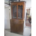 An Edwardian inlaid mahogany bookcase cabinet with twin glazed doors, two drawers and two doors on