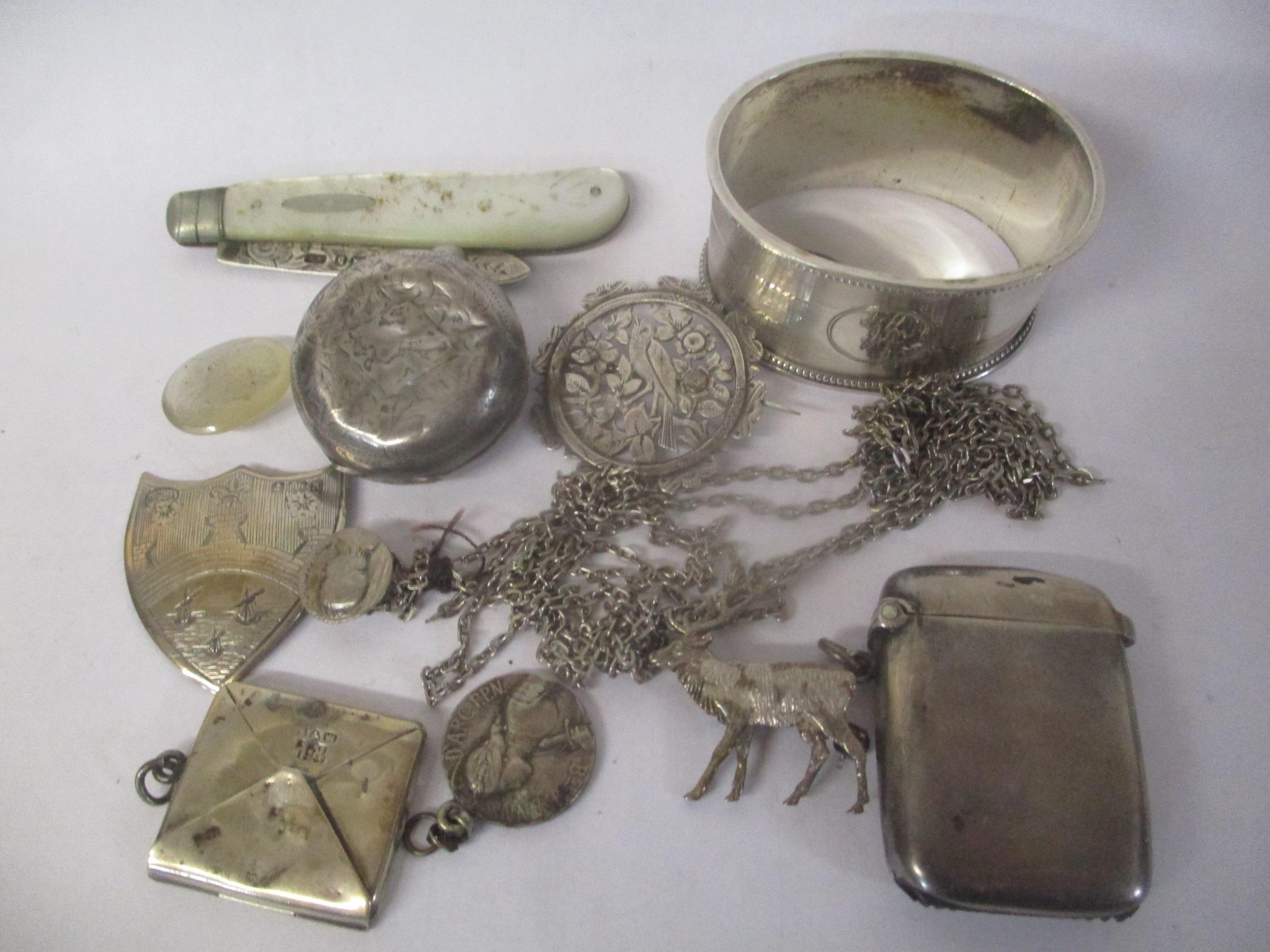 A mixed lot to include a silver vesta case, stamp case, sovereign holder and other items