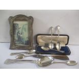 Mixed silver to include a picture frame, together with a white metal serving spoon. Weight excluding