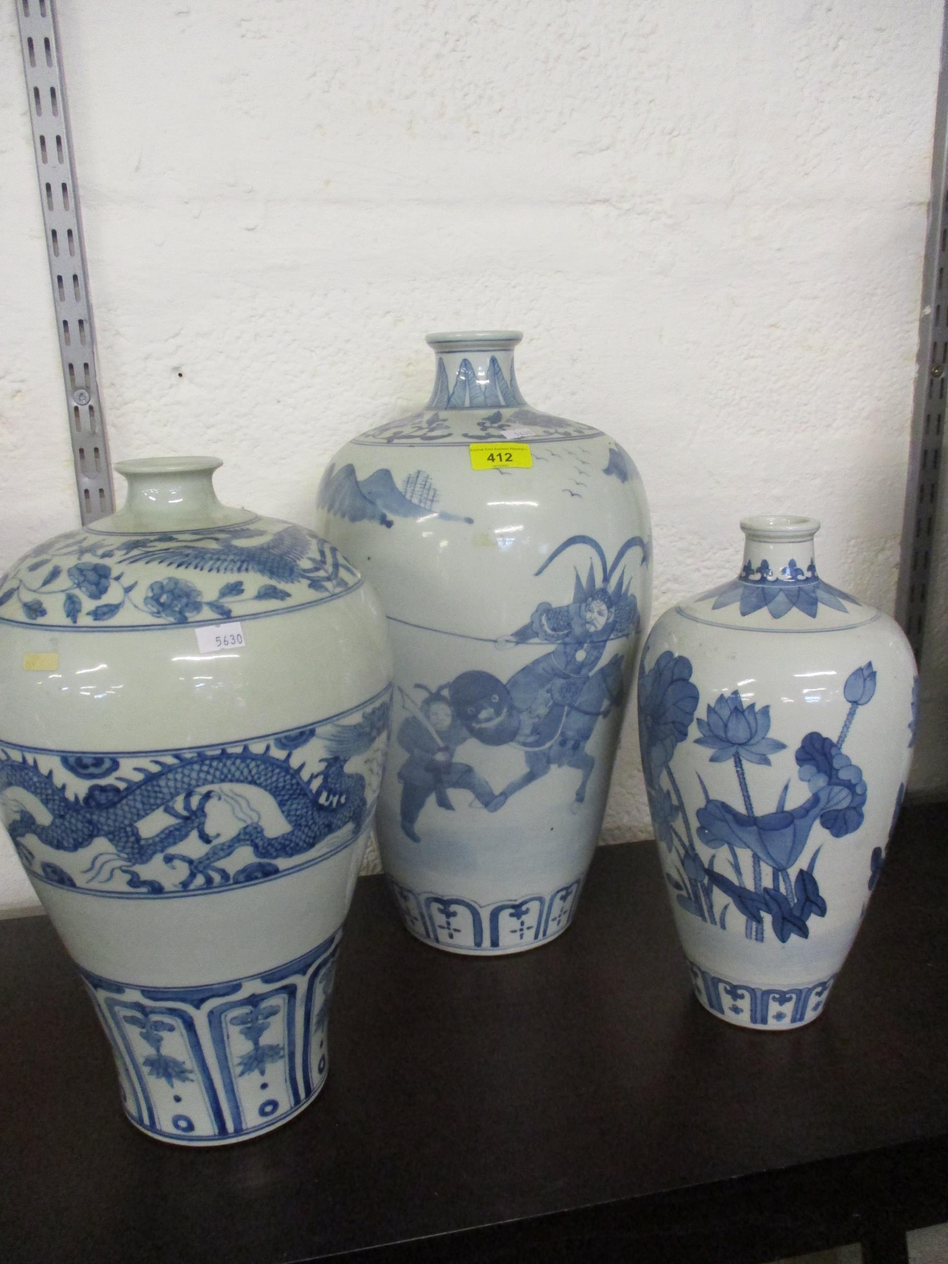 A group of three 20th century Chinese blue and white vases in varying sizes and colours, the tallest