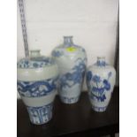 A group of three 20th century Chinese blue and white vases in varying sizes and colours, the tallest