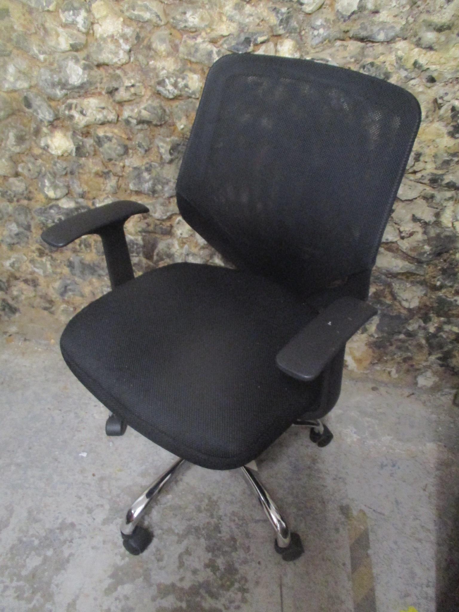 A fabric and plastic office chair on a chrome base