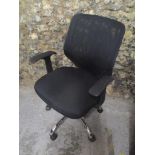 A fabric and plastic office chair on a chrome base